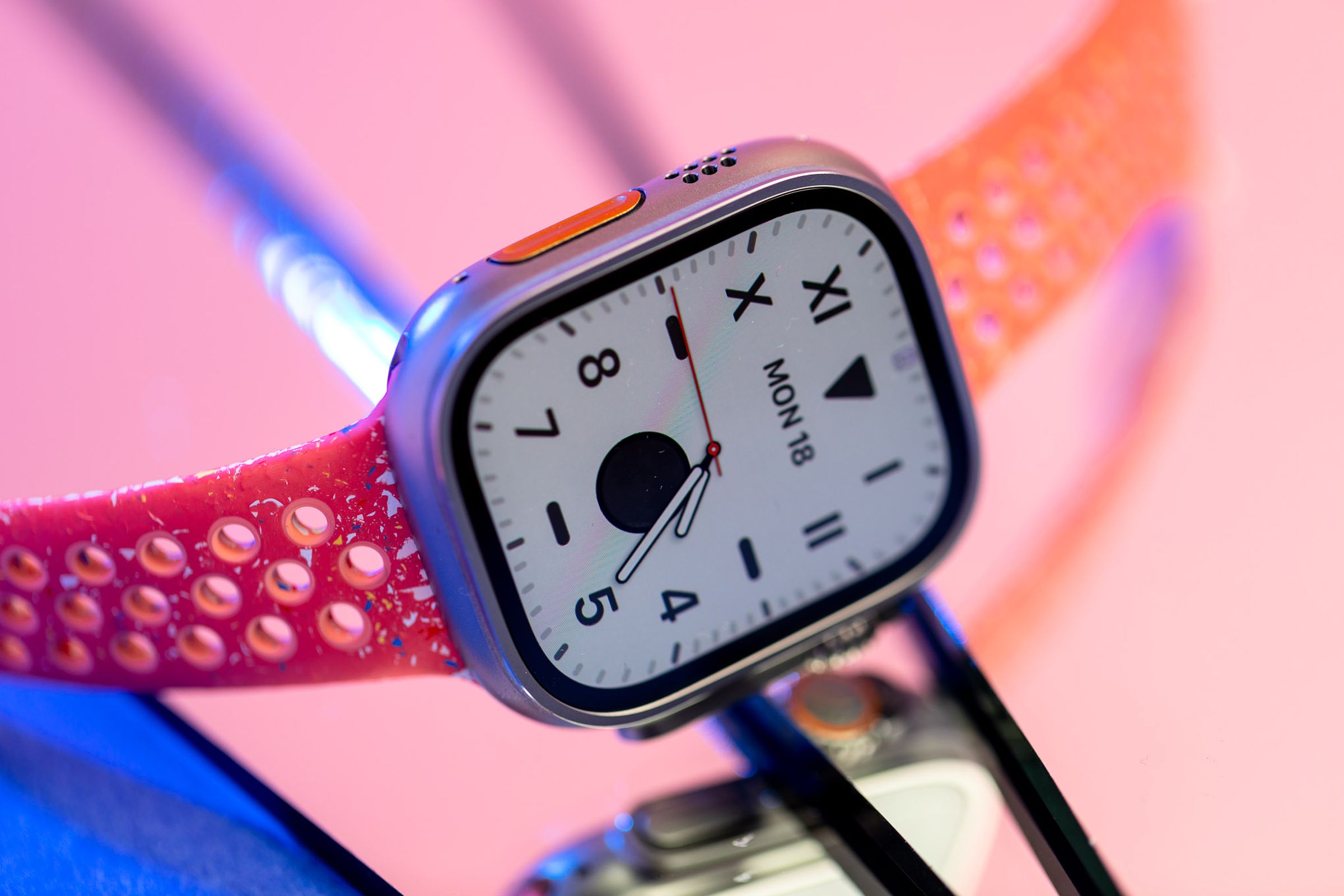Apple Watch Ultra 2 on a reflecive pink surface
