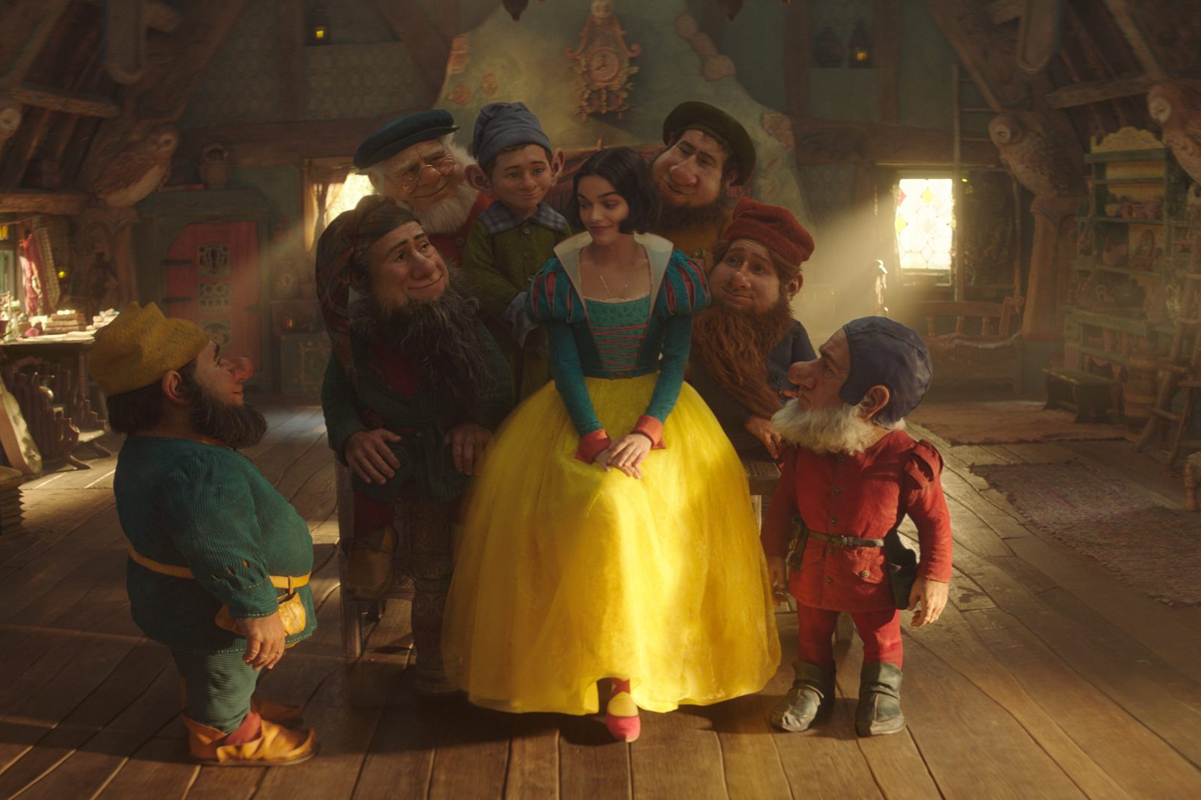 Snow White (Rachel Zegler) and (alphabetically) Bashful, Doc, Dopey, Grumpy, Happy, Sleepy, and Sneezy, in Disney’s Snow White.