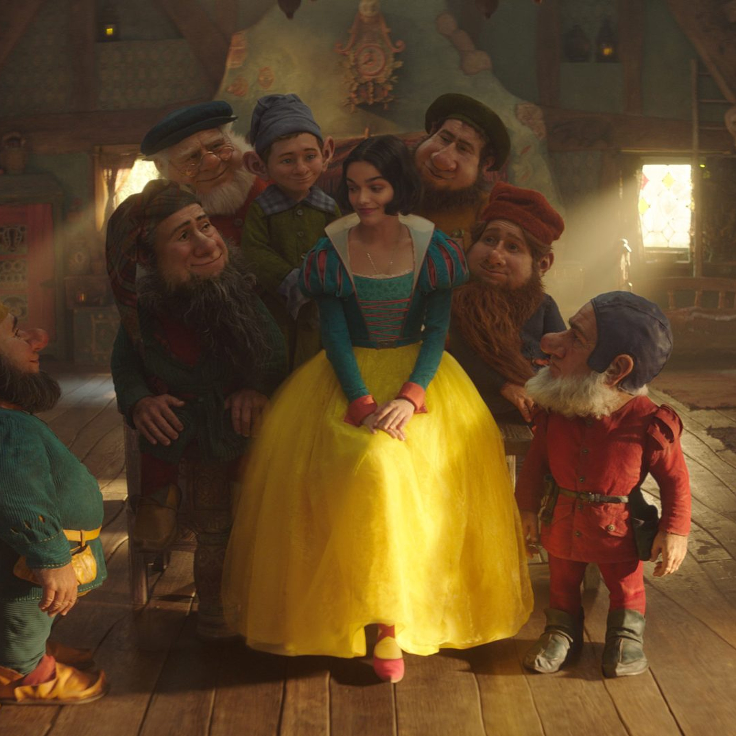 Snow White (Rachel Zegler) and (alphabetically) Bashful, Doc, Dopey, Grumpy, Happy, Sleepy, and Sneezy, in Disney’s Snow White.