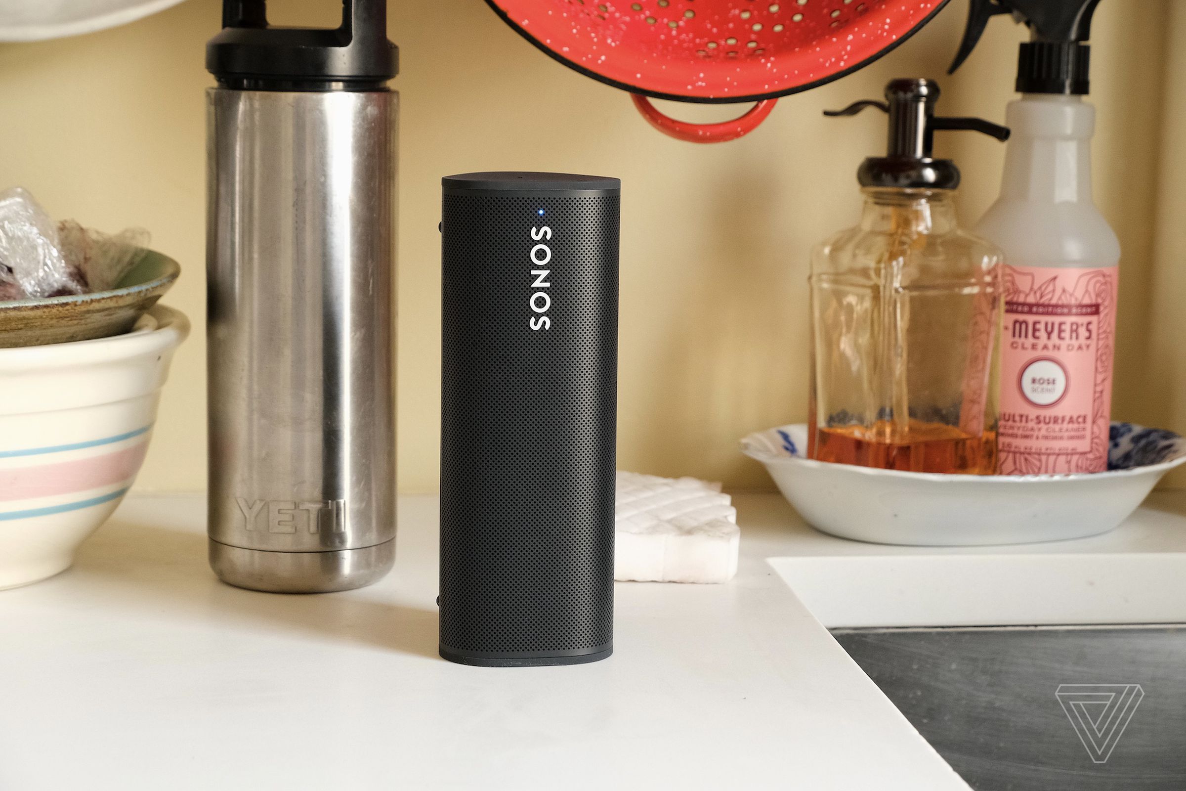 A photo of the Sonos Roam speaker on a kitchen counter.